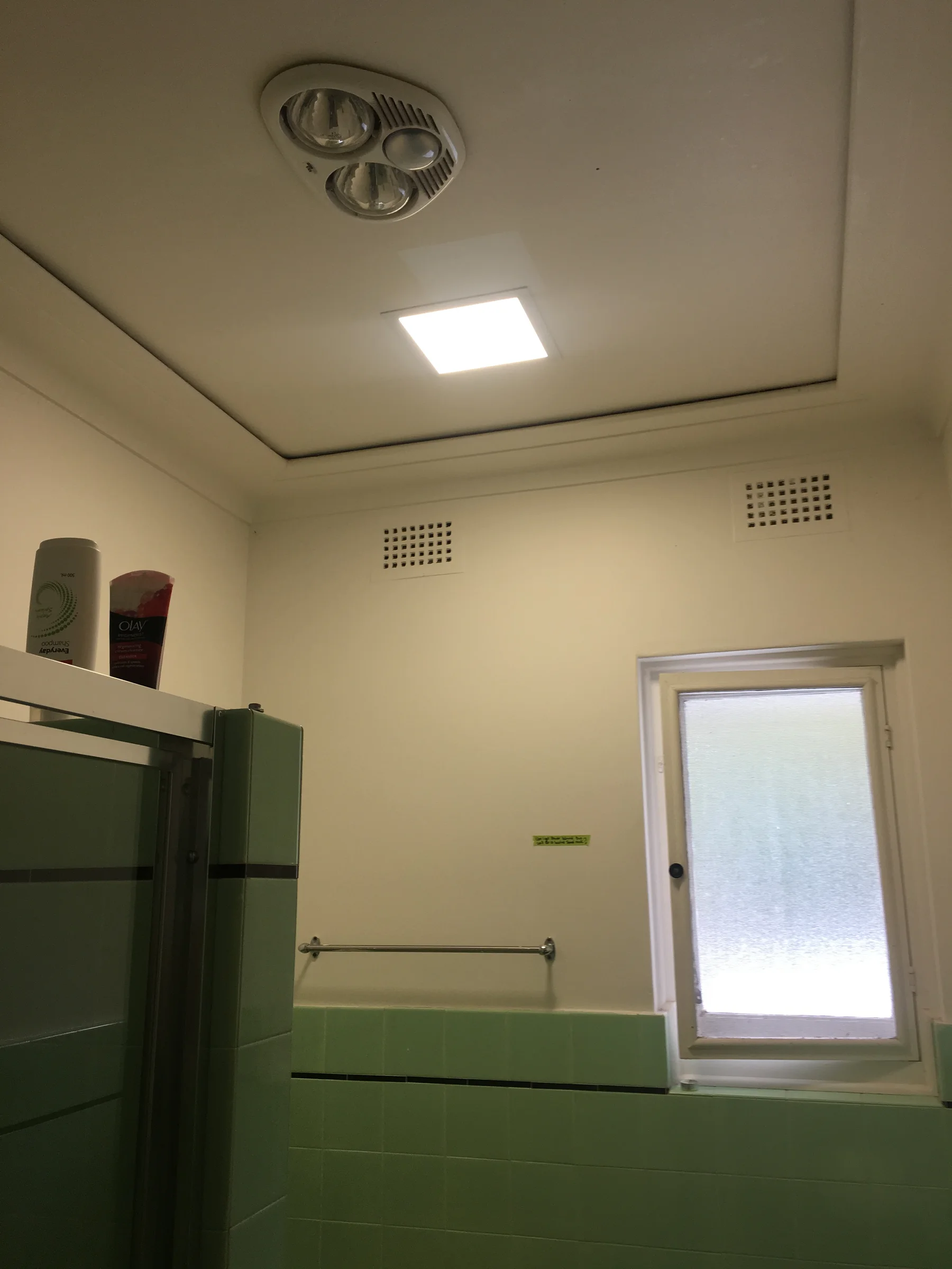 The same ceiling light fitting switched on in a Palm Beach bathroom