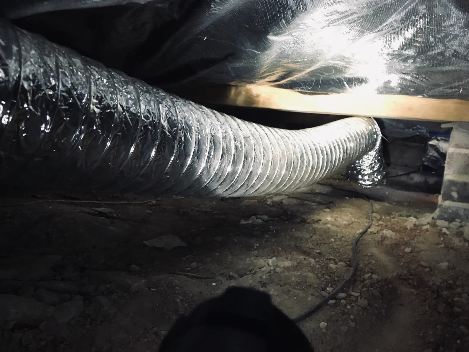 Flexible ventilation ductwork installed beneath a home in Epping