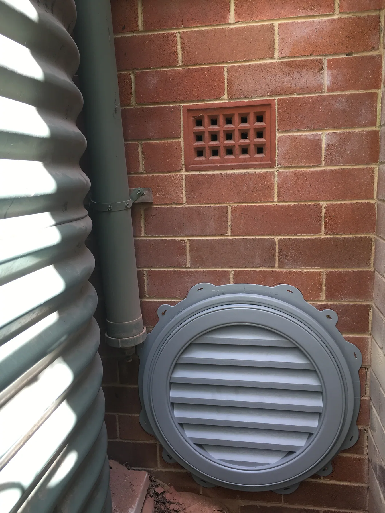Wall-mounted subfloor ventilation fan at a Chatswood home